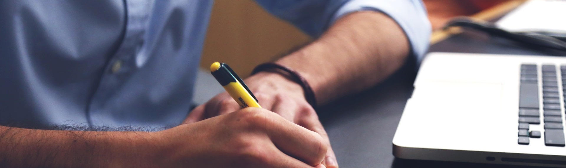 A person writing with a pen